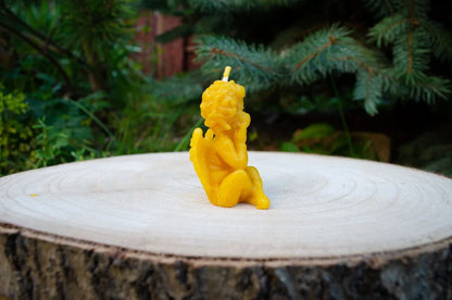 Šonu pastatytas sėdintis angeliukas